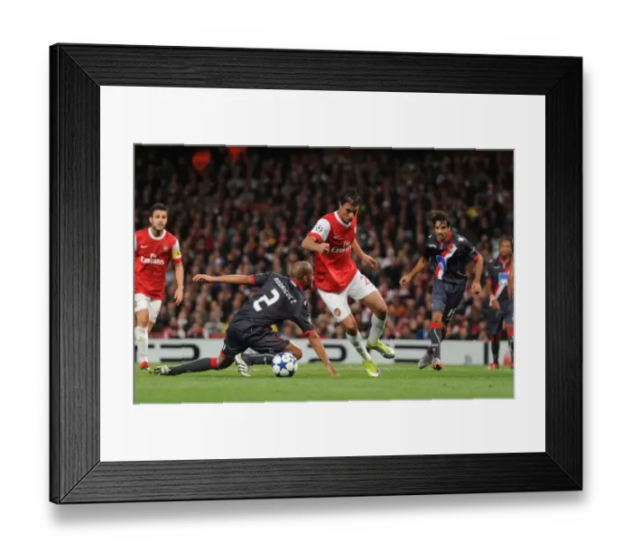 Framed Print : Marouane Chamakh breaks past Braga defender Alberto Rodriguez to score the 3rd Arsenal goal