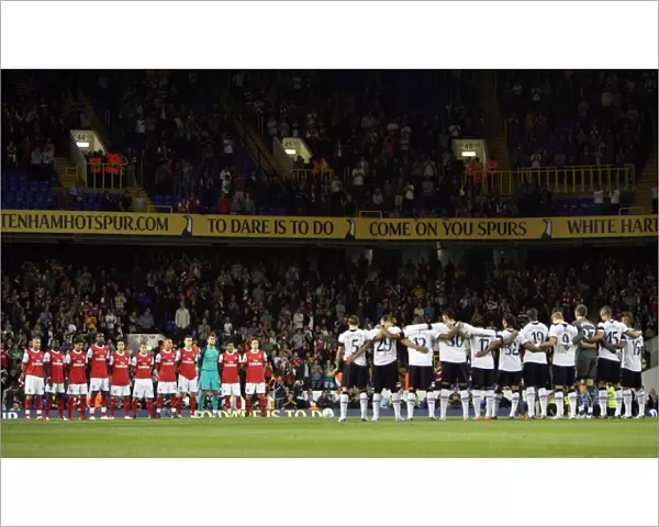 Arsenal and Tottenham players observe a minutes applause for Tottenham player Bobby Smith
