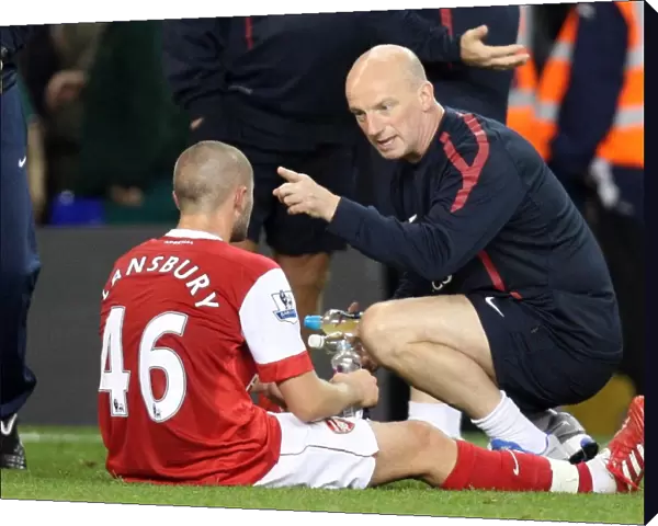 JK talks to Henri Lansbury (Arsenal) during the break before extra time