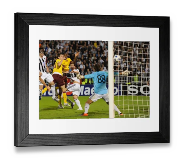Framed Print : Sebastien Squillaci heads past Partizan goalkeeper Vladimir Stojkovic to score the 3rd Arsenal goal