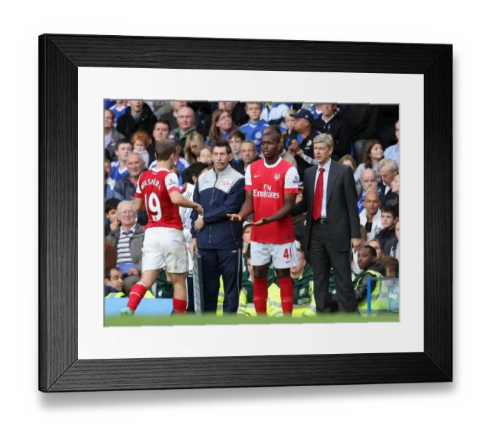 Framed Print : Arsene Wenger the Arsenal Manager with Jay Emmanuel Thomas who is coming on for Jack Wilshere
