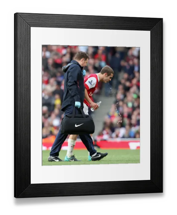Framed Print : Jack Wilshere (Arsenal) gets treatment for a bloody lip from Physio Colin Lewin