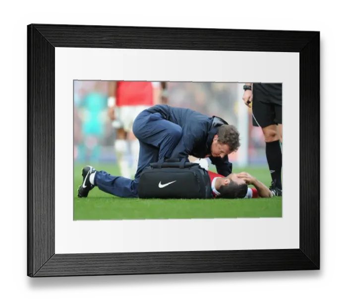 Framed Print : Arsenal physio Colin Lewin treats Cesc Fabregas. Arsenal 1: 0 West Ham United