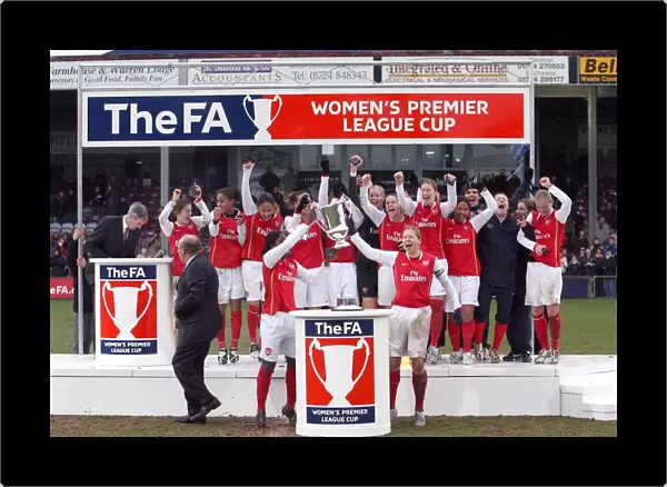 Jayne Ludlow and Anita Asante lift the League Cup Trophy for Arsenal
