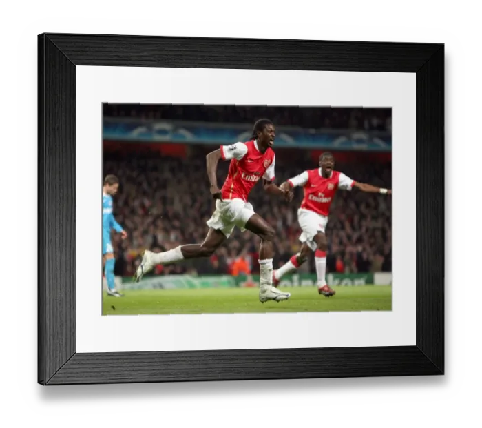 Framed Print : Emmanuel Adebayor (Arsenal) celebrates the own goal scored by Alex (PSV, not pictured)