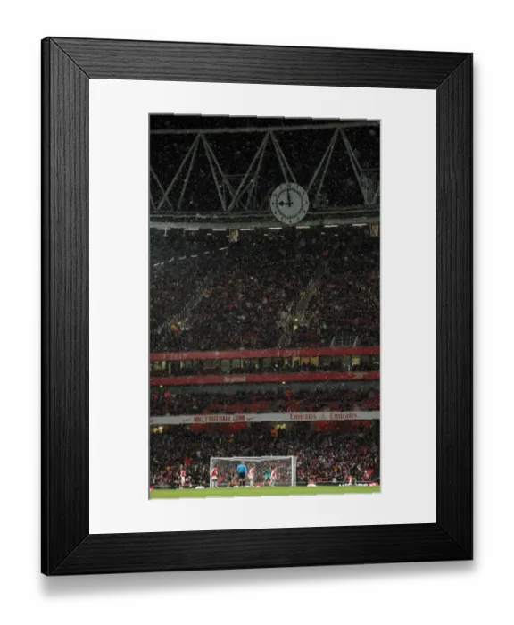 Framed Print : Snow falls across the Clock End during the match. Arsenal 2: 0 Wigan Athletic