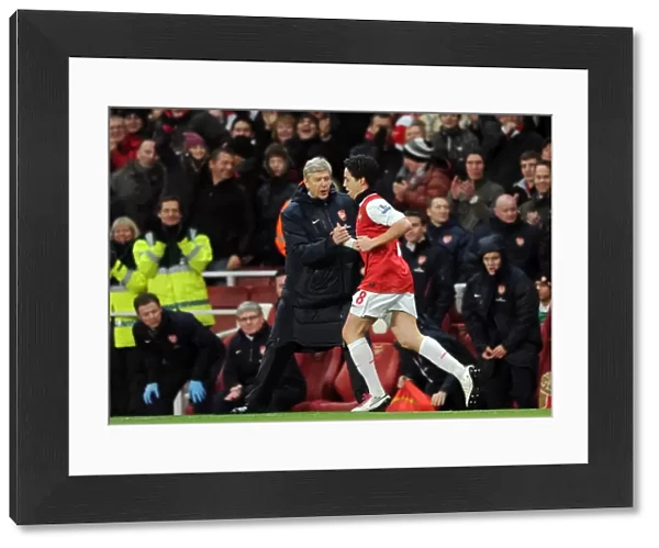 Arsene Wenger the Arsenal Manager congratulates Samir Nasri (Arsenal) on his 2nd goal