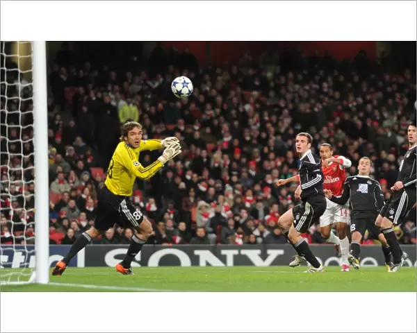 Theo Walcott shoots past Partizan goalkeeper Vladimir Stojkovic to score the 2nd Arsenal goal