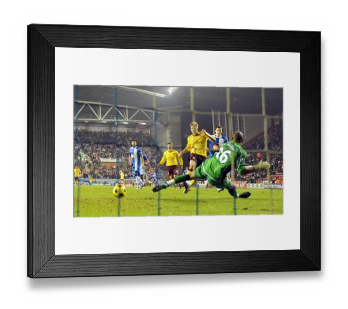 Framed Print : Nicklas Bendtner shoots past Wigan goalkeeper Ali Al Habsi to score the 2nd Arsenal goal Framed Print : Nicklas Bendtner shoots past Wigan goalkeeper Ali Al Habsi to score the 2nd Arsenal goal