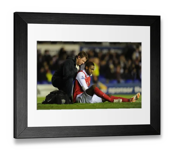 Framed Print : Johan Djourou is treated by Arsenal physio Colin Lewin. Birmingham City 0: 3 Arsenal