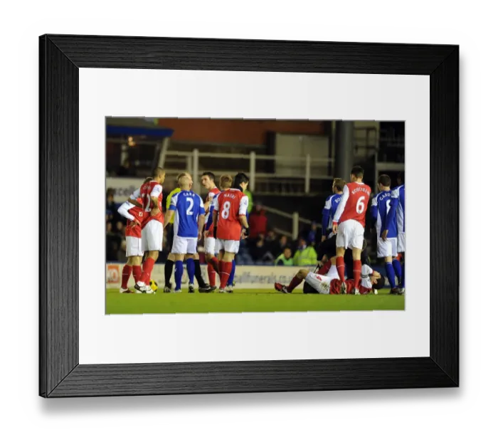 Framed Print : Cesc Fabregas (Arsenal) inured by a tackle by Birmingham defender Roger Johnson