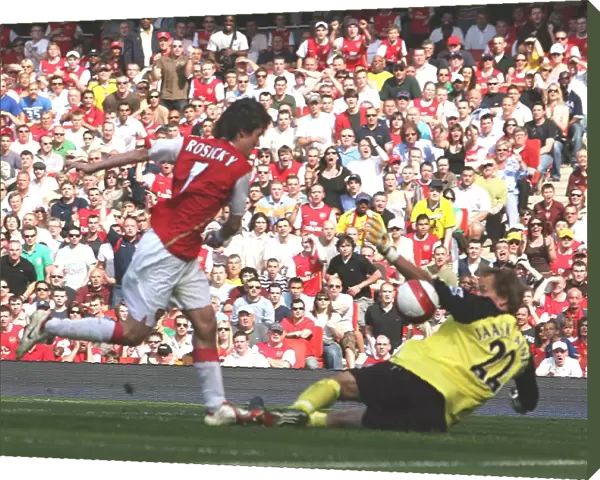 Tomas Rosicky shoots past Bolton goalkeeper Jussi Jaskelainen to score the first Arsenal goal