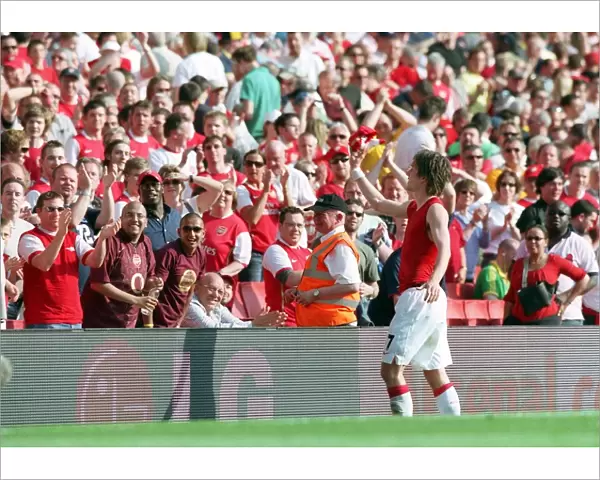 Tomas Rosicky (Arsenal) throws his shirt to the fans after the match
