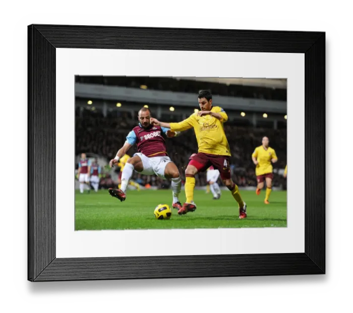 Framed Print : Cesc Fabregas Scores the Game-Winning Goal Against Julien Faubert and West Ham United in Arsenal's 3-0 Victory