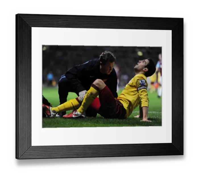 Framed Print : Arsenal captain Cesc Fabregas is treated by physio Colin Lewin. West Ham United 0 Framed Print : Arsenal captain Cesc Fabregas is treated by physio Colin Lewin. West Ham United 0