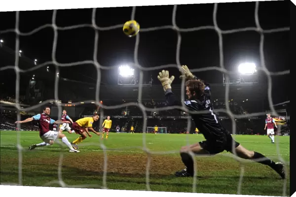 Theo Walcott shoots past West Ham goalkeeper to score the 2nd Arsenal goal