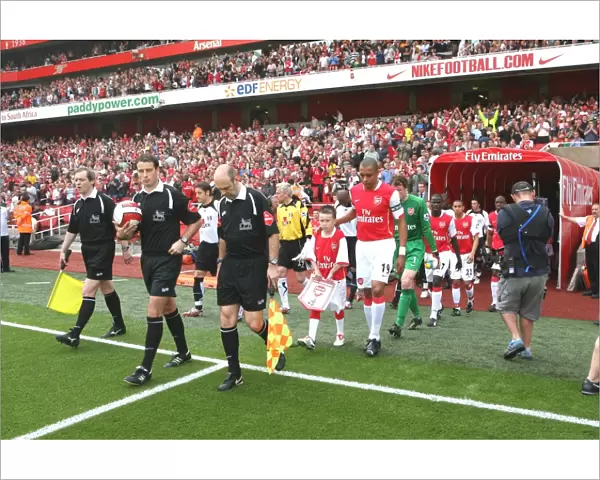 Gilberto leads out the Arsenal team before the match