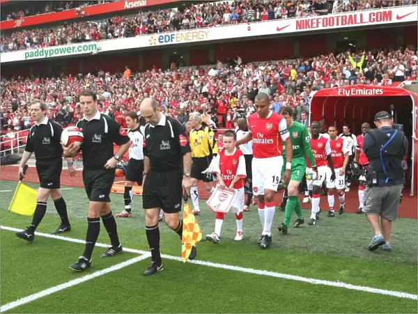 Gilberto leads out the Arsenal team before the match