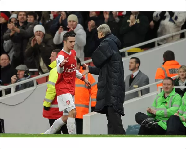 Robin van Persie (Arsenal) is congratulated by Manager Arsene Wenger on his hat trick as he is subbed. Arsenal 3: 0 Wigan Athletic. Barclays Premier League. Emirates Stadium, 22  /  1  /  11. Credit : Arsenal Football Club  / 