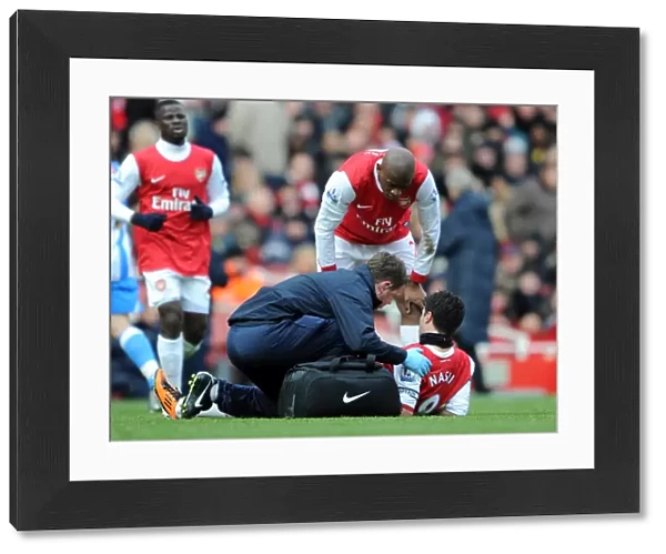 Colin Lewin and Abou Diaby check on the injured Samir Nasri (Arsenal). Arsenal 2