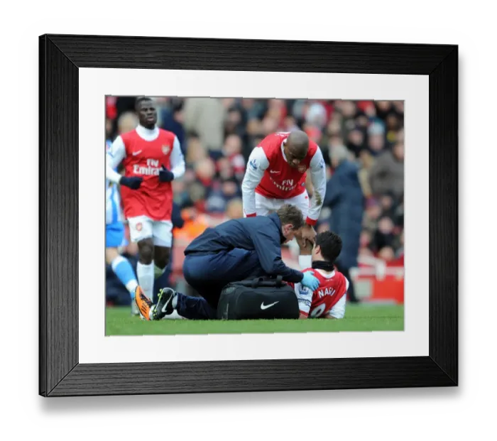 Framed Print : Colin Lewin and Abou Diaby check on the injured Samir Nasri (Arsenal). Arsenal 2