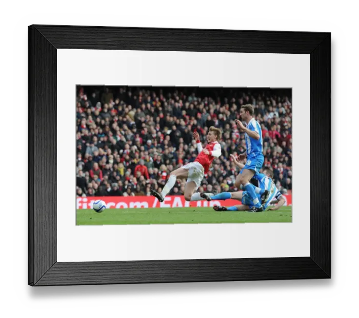 Framed Print : Nicklas Bendtner is tripped by Huddersfield defender Jamie McCombe for thre Arsenal penalty Framed Print : Nicklas Bendtner is tripped by Huddersfield defender Jamie McCombe for thre Arsenal penalty