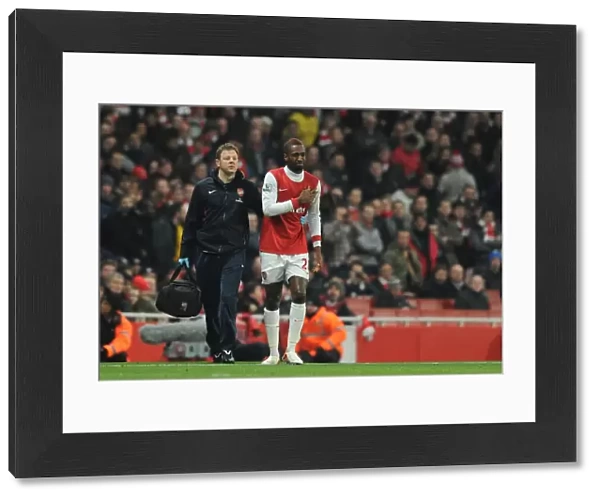 Johan Djourou with Arsenal physio Colin Lewin. Arsenal 2: 1 Everton, Barclays Premier League