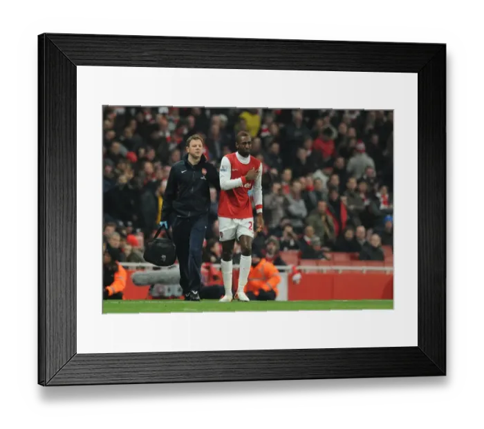 Framed Print : Johan Djourou with Arsenal physio Colin Lewin. Arsenal 2: 1 Everton, Barclays Premier League