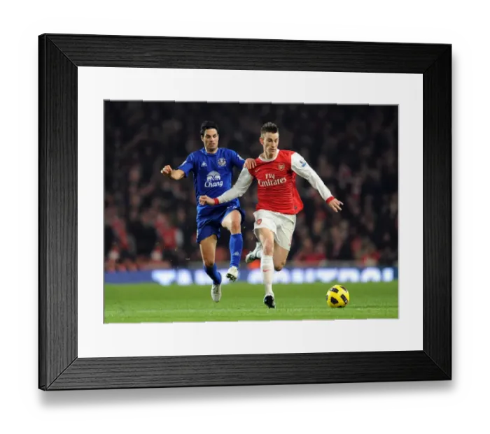 Framed Print : Koscielny vs. Arteta Clash: Arsenal's Win over Everton in the Barclays Premier League