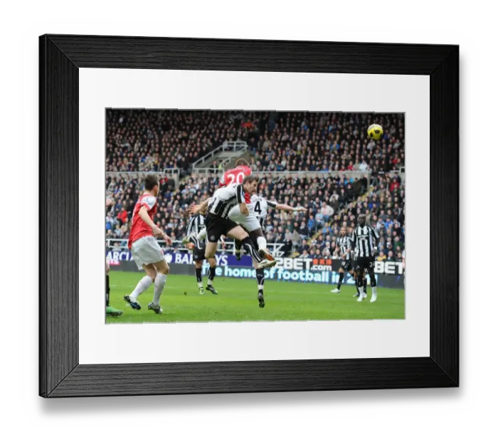 Framed Print : Johan Djourou heads past Newcastle goalkeeper Steve Harper to score the 2nd Arsenal goal