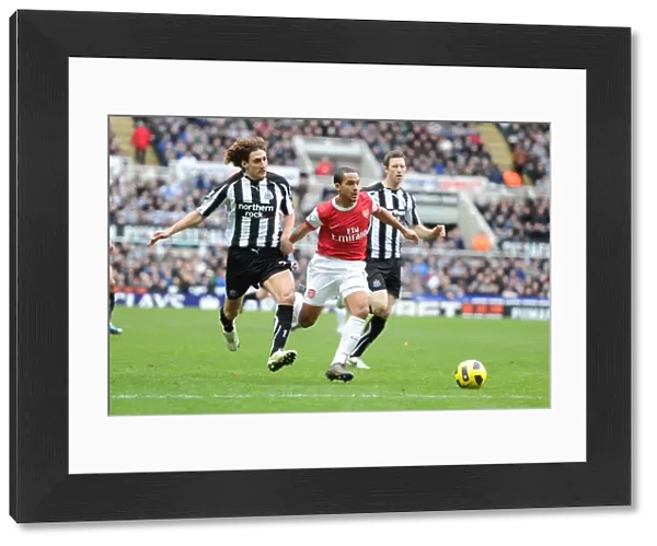 Theo Walcott breaks past Newcastle defender Fabricio Coloccini to score the 1st Arsenal goal