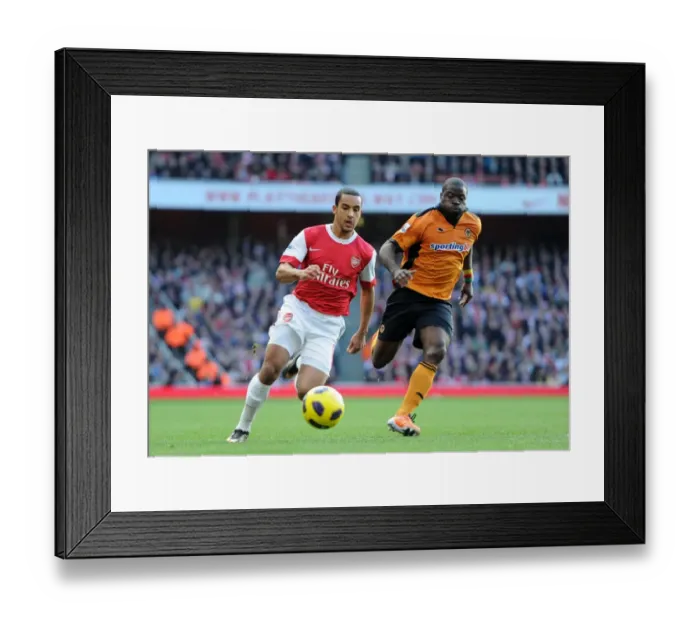 Framed Print : Theo Walcott (Arsenal) George Elokobi (Wolves). Arsenal 2: 0 Wolverhampton Wanderers Framed Print : Theo Walcott (Arsenal) George Elokobi (Wolves). Arsenal 2: 0 Wolverhampton Wanderers