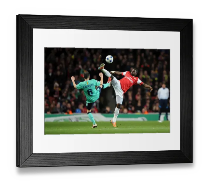 Framed Print : Eboue vs Iniesta: Arsenal's Victory Over Barcelona in the UEFA Champions League (2011)