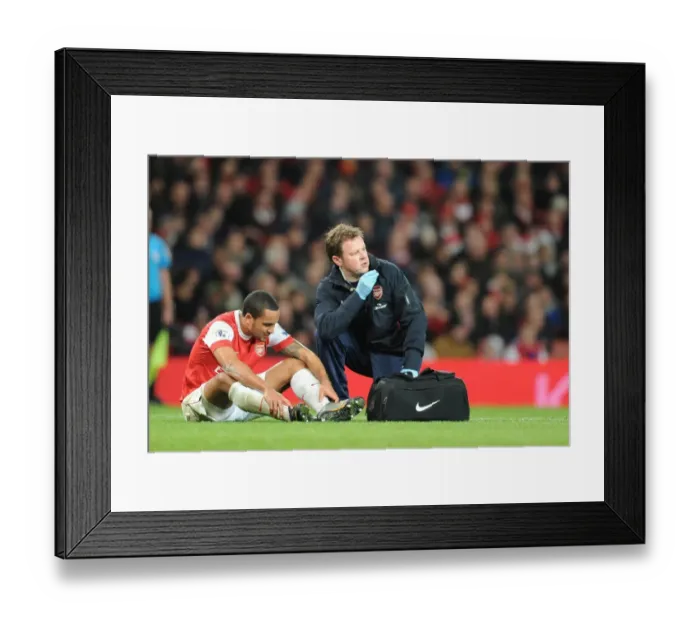 Framed Print : Arsenal physio Colin Lewin treats injured Theo Walcott. Arsenal 1: 0 Stoke City Framed Print : Arsenal physio Colin Lewin treats injured Theo Walcott. Arsenal 1: 0 Stoke City