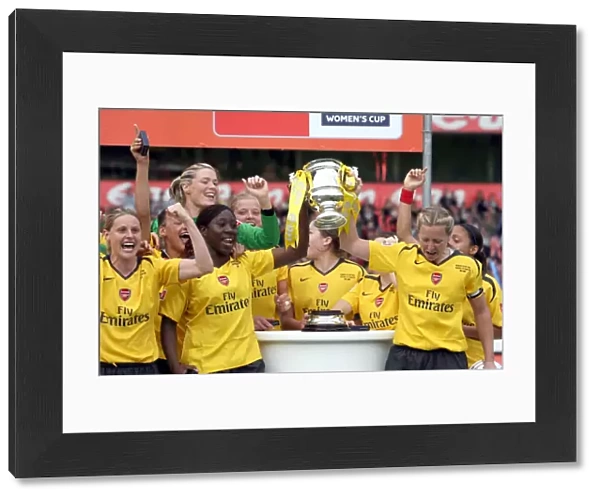 Anita Asanta and Jayne Ludlow (Arsenal) lift the FA Cup Trophy
