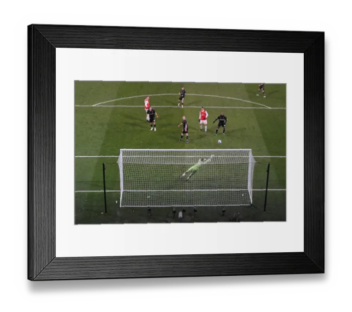 Framed Print : Nicklas Bendtner heads past Orient goalkeeper Jamie Jones to score the 2nd Arsenal goal