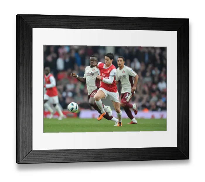 Framed Print : Nasri vs Muntari: A Battle of Midfielders Ends in a Draw at Emirates
