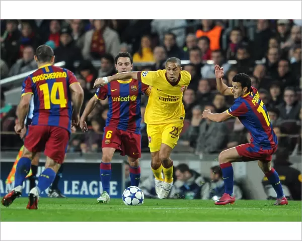 Gael Clichy (Arsenal) takes on Xavi and Pedro Rodriguez (Barcelona). Barcelona 3