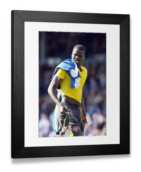 Framed Print : Emmanuel Eboue (Arsenal) gives his boots to a fan after the match Framed Print : Emmanuel Eboue (Arsenal) gives his boots to a fan after the match