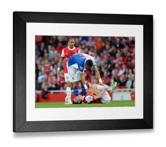 Framed Print : Laurent Koscielny (Arsenal) lies injuered following a challenge from Steven N Zonzi