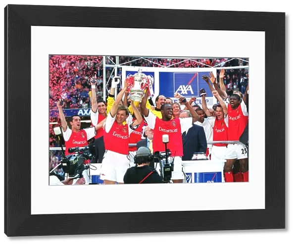 Arsenal captain Tony Adams and vice-captain Patrick Vieira lift the FA Cup