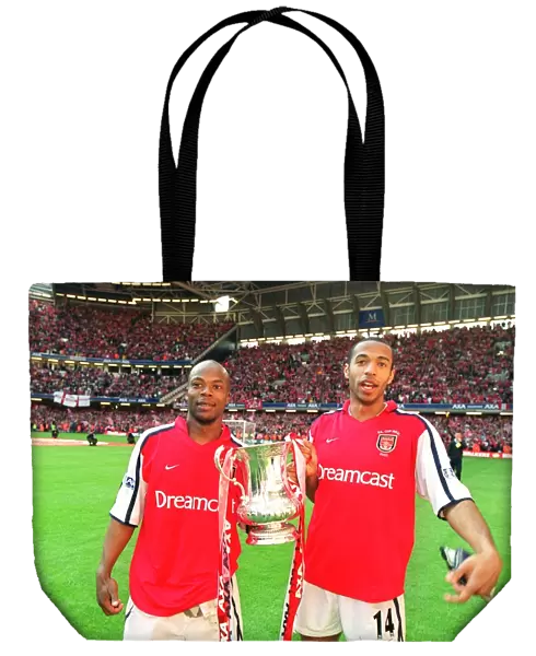 Thierry Henry and Sylvain Wiltord celebrate the Arsenal victory