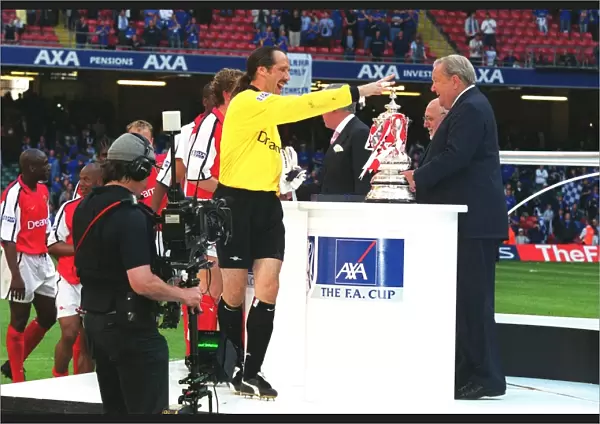 Arsenal goalkeeper David Seaman collects his medal from Leonart Johanssen