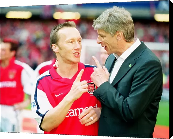 Arsenal manager Arsene Wenger with defender Lee Dixon after the match