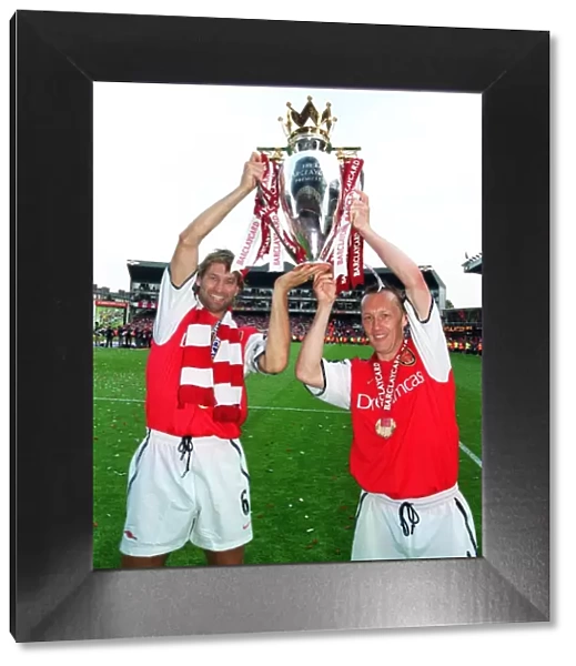 Arsenal captain Tony Adams and Lee Dixon lift the F. A