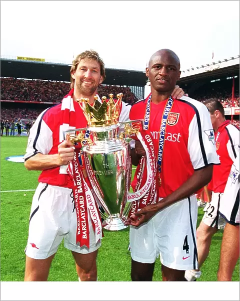 Arsenal cpatain Tony Adams and vice-captain Patrick Vieira lift the F. A