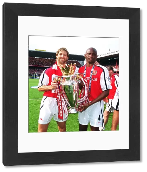 Arsenal cpatain Tony Adams and vice-captain Patrick Vieira lift the F. A