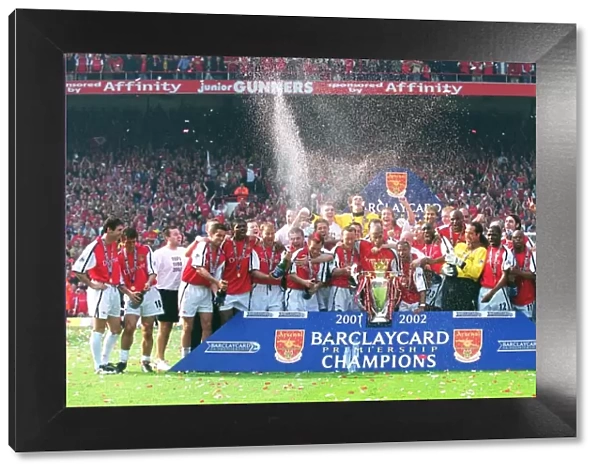 The Arsenal team celebrate winning the F. A. Barclaycard Premiership