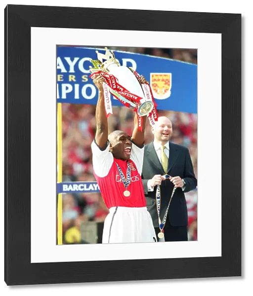 Sol Campbell lifts the F. A. Barclaycard Premiership Trophy