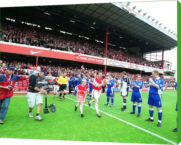 Arsenal captain Lee Dixon leads the team out onto the pitch for the match